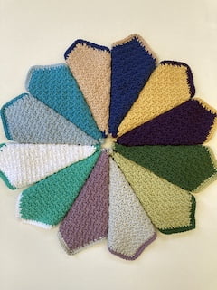 ring of coloured crochet face cloths